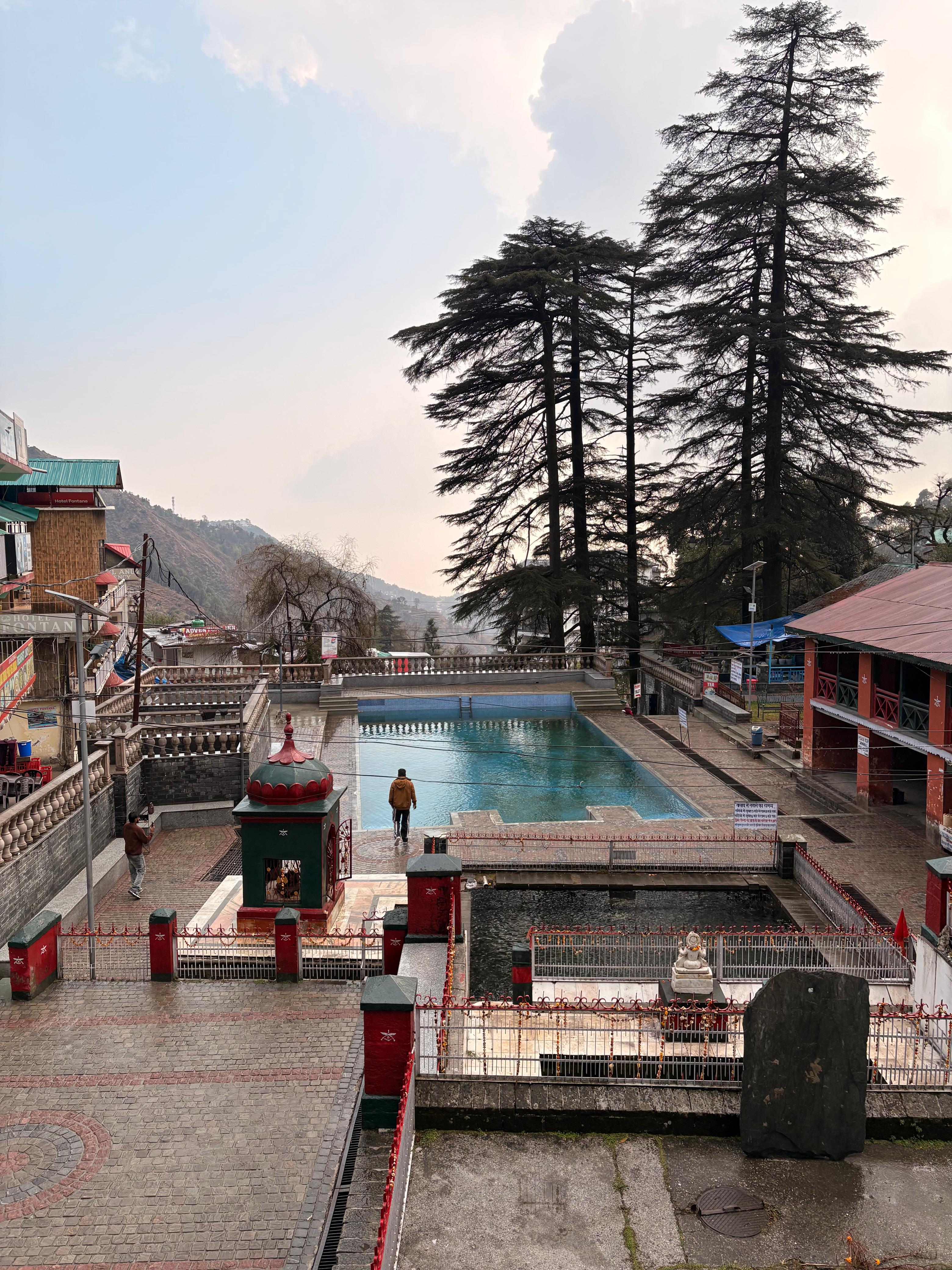 Bhagsunath Temple sacred tank surrounded by cedar trees, Dharamshala