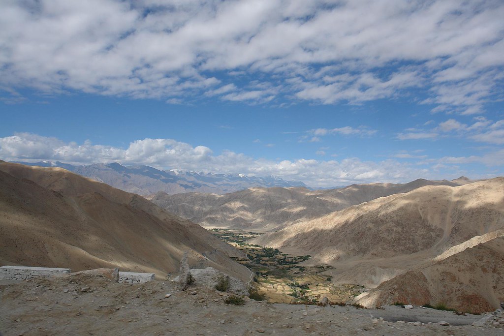 Arid Ladakhi mountain landscape with green valley below, viewed from a high pass