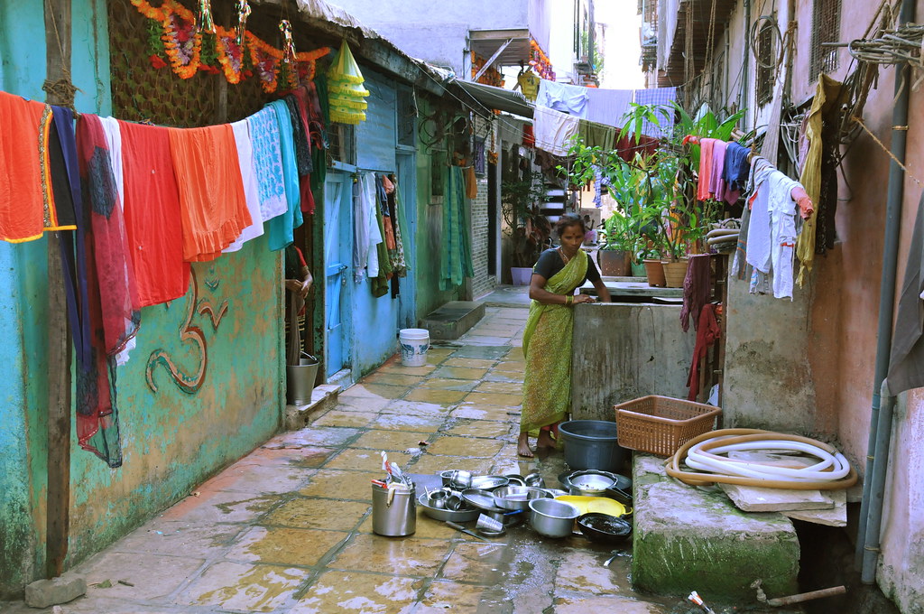 Narrow lane in Dharavi with colourful walls and laundry, Mumbai