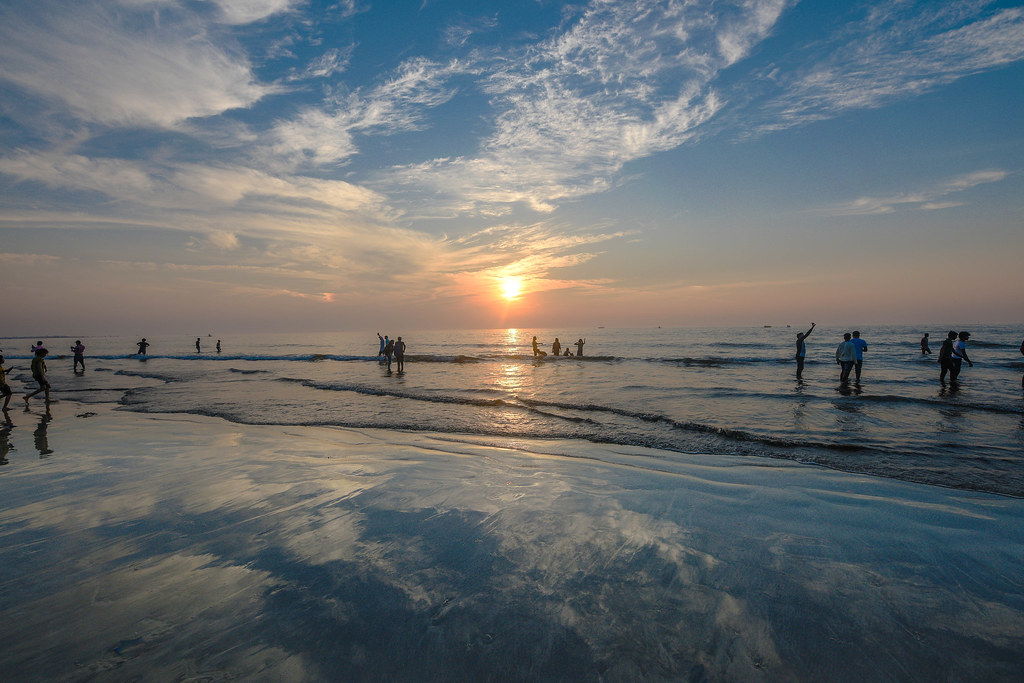 Juhu Beach at sunset — silhouettes in the waves, Mumbai