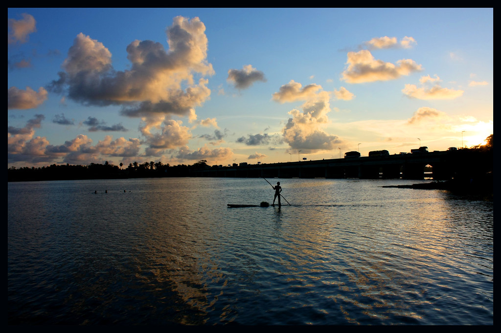 Silhouette of a paddleboarder at sunset on the Pondicherry backwaters