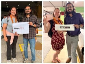 Woman arriving at Delhi airport at night met by a RoamRani holding a placard